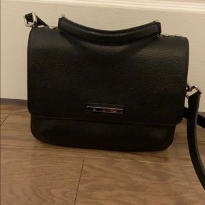 Black satchel bag with top handle and crossbody